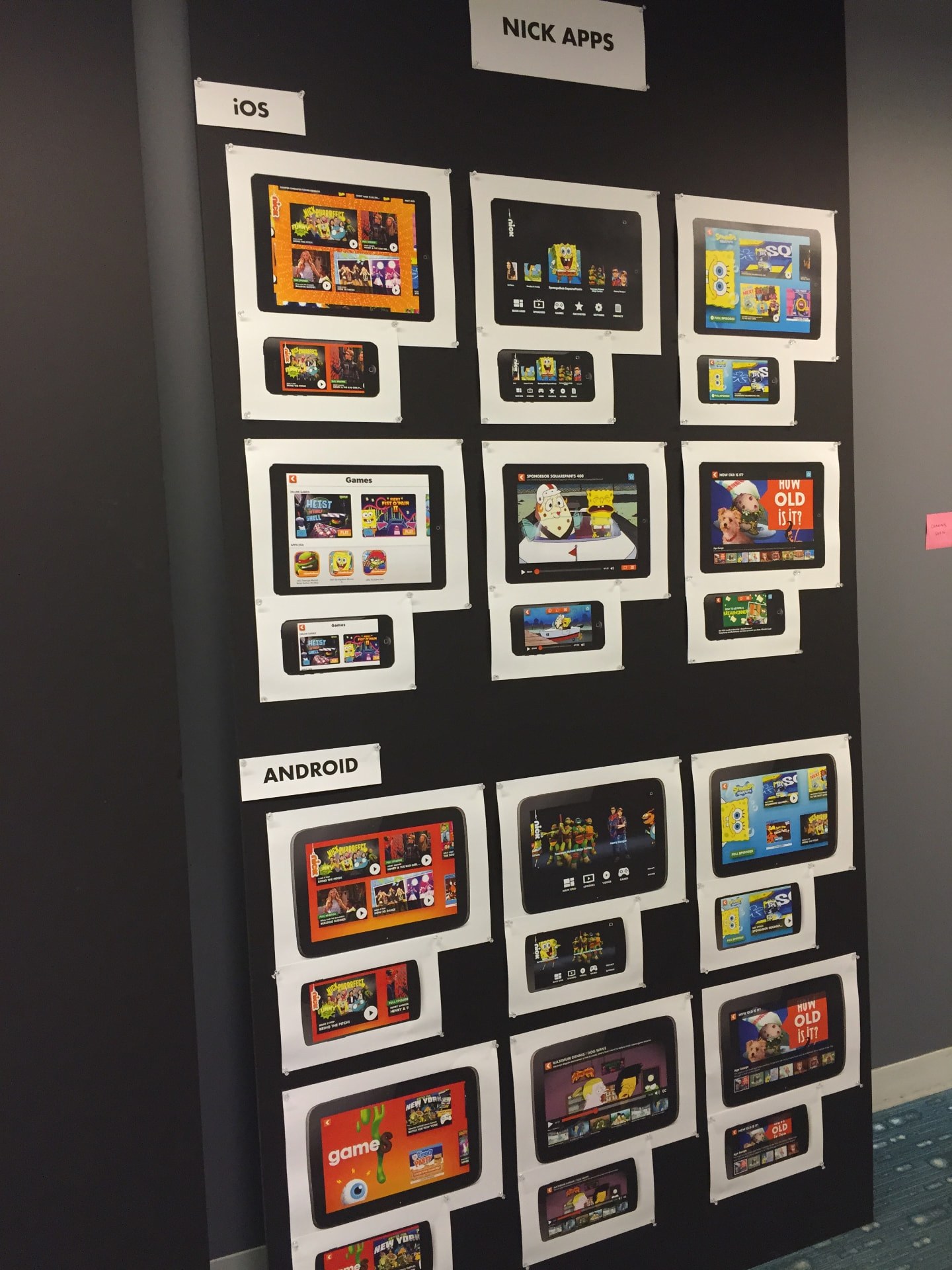 Nick Apps design review wall — printed desktop, tablet and mobile screens