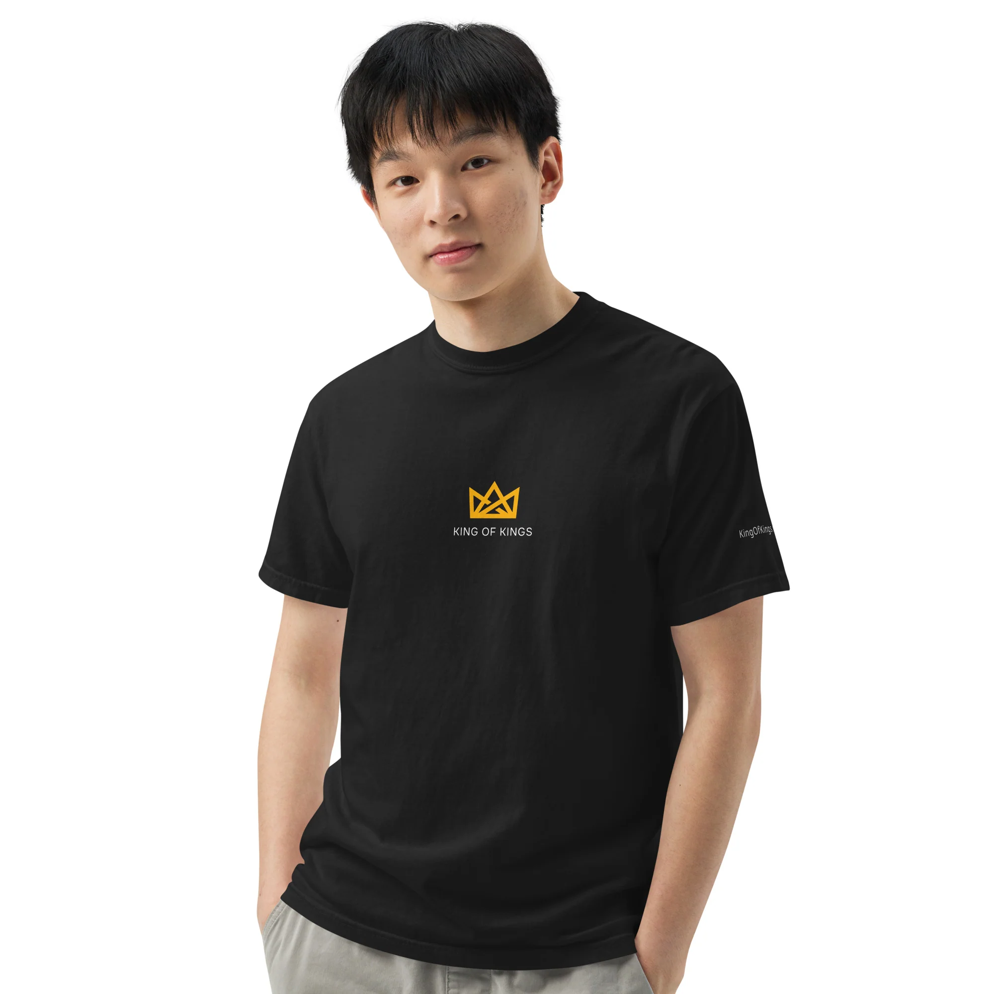 Model wearing the black King of Kings T-shirt, front view, with a small gold crown and wordmark on the chest