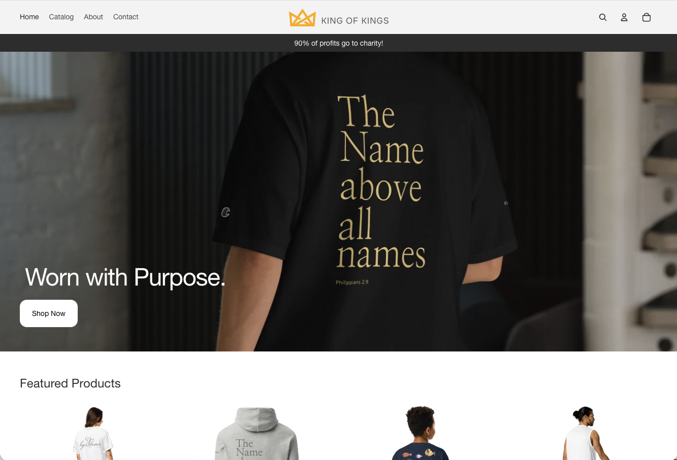 King of Kings online store homepage with the centered crown logo, a “90% of profits go to charity” message, and the “Worn with Purpose” hero